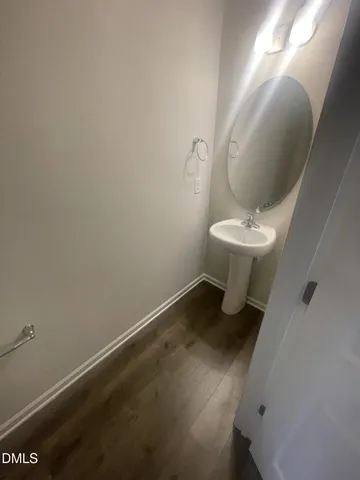 a bathroom with a sink toilet and a mirror