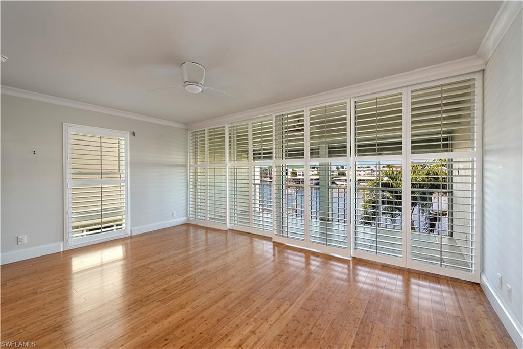 800 River Point Drive, Unit 207 Naples, FL 34102 - Photo 5 of 12 an empty room with wooden floor and windows