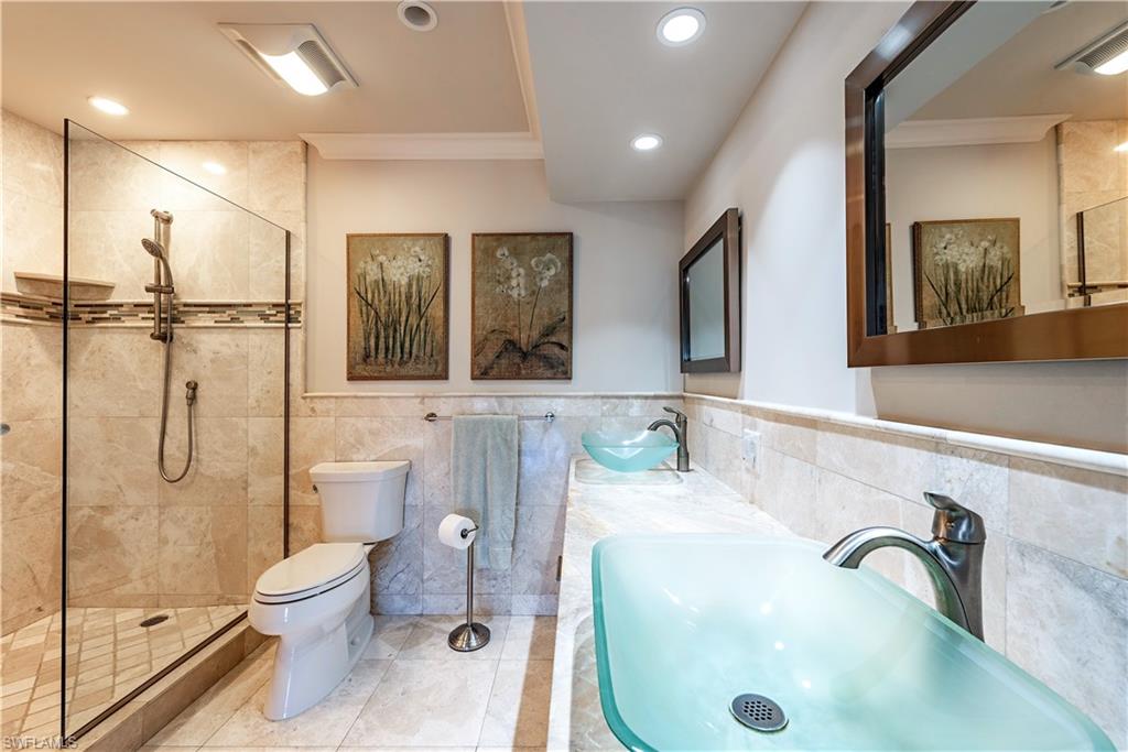800 River Point Drive, Unit 207 Naples, FL 34102 - Photo 6 of 12 a bathroom with a toilet sink and shower