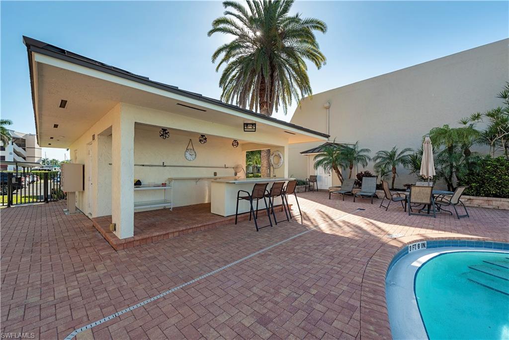800 River Point Drive, Unit 207 Naples, FL 34102 - Photo 10 of 12 a view of a house with outdoor seating area