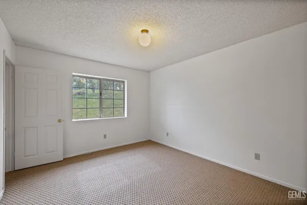 a view of a balcony with chairs and wooden floor