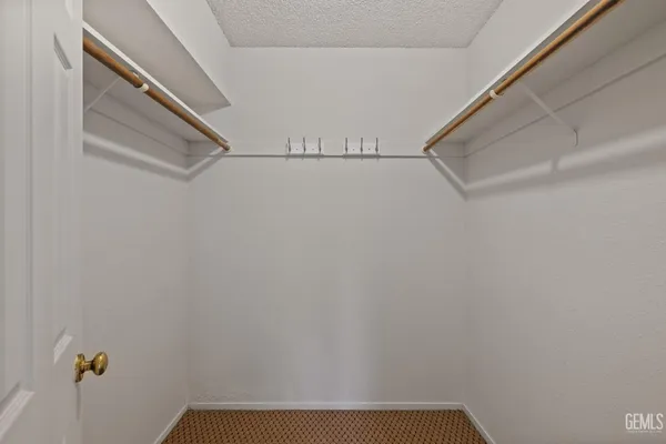 a kitchen with stainless steel appliances a sink cabinets and wooden floor
