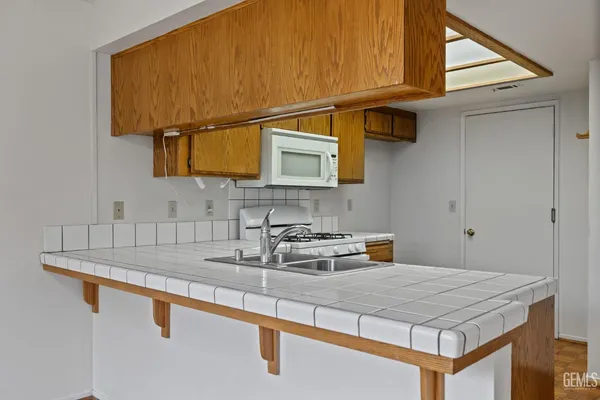 a view of an empty room with a window and a chandelier