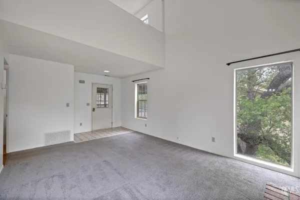 an empty room with furniture and a fireplace