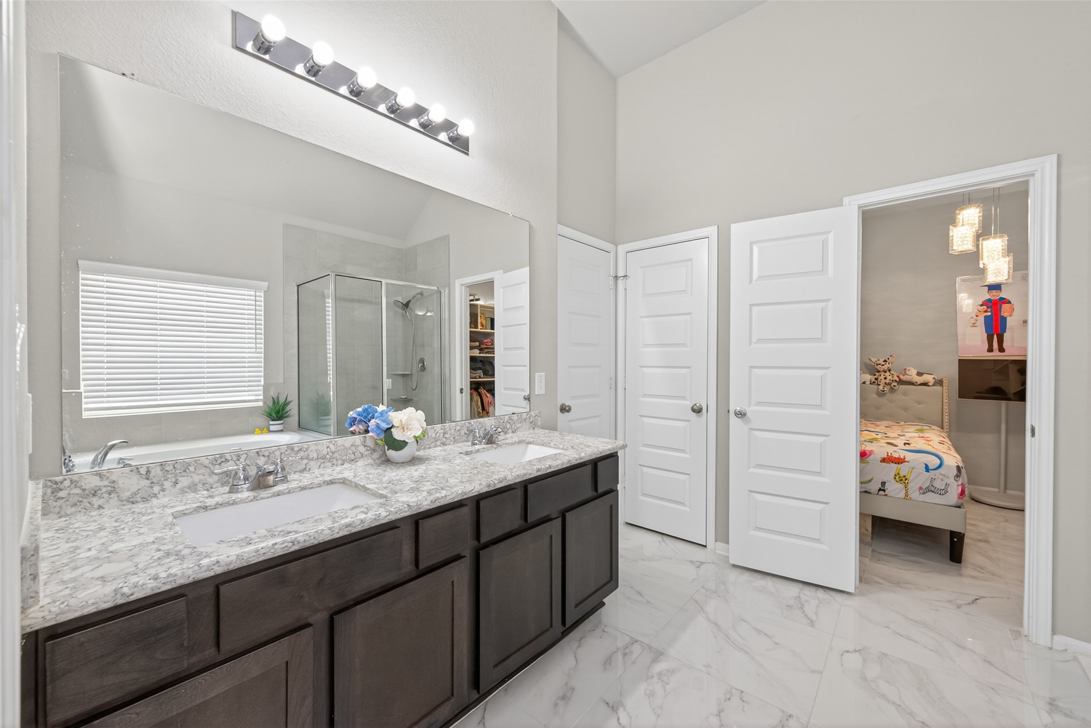 22409 Kinley Street New Caney, TX 77357 - Photo 33 of 46 a en suite bathroom with double sink and a large mirror