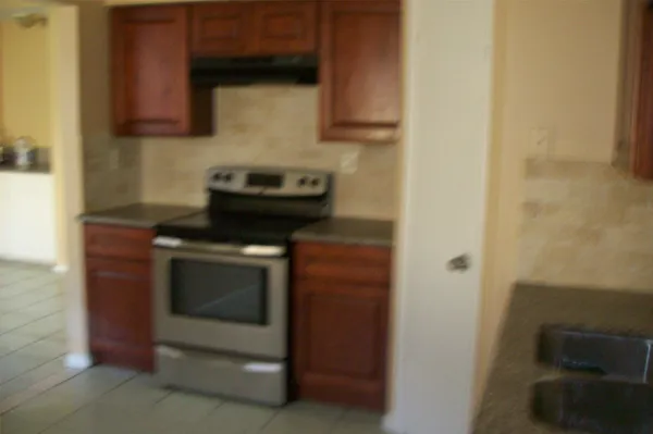 a kitchen with a stove and a microwave