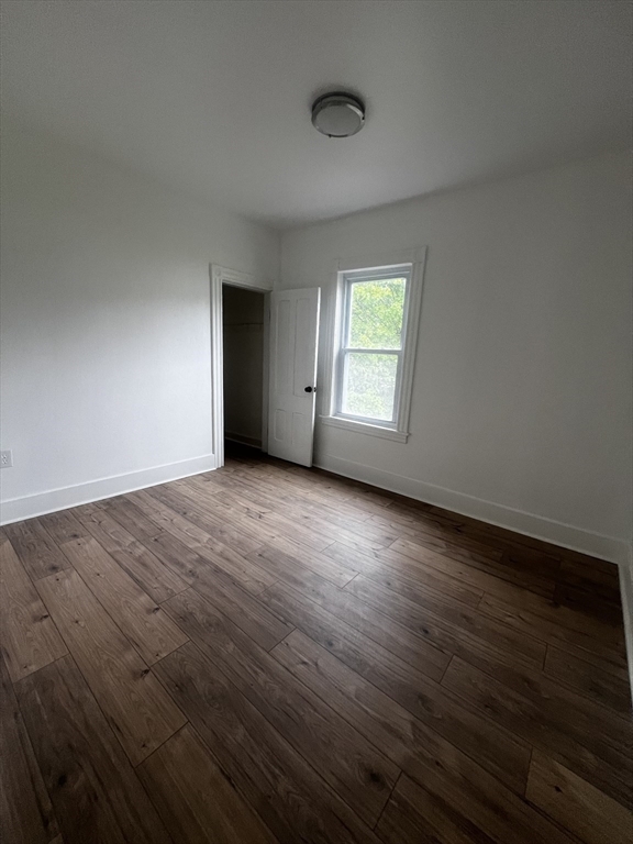 19 Reeves Street Worcester, MA 01607 - Photo 23 of 30 an empty room with wooden floor and windows