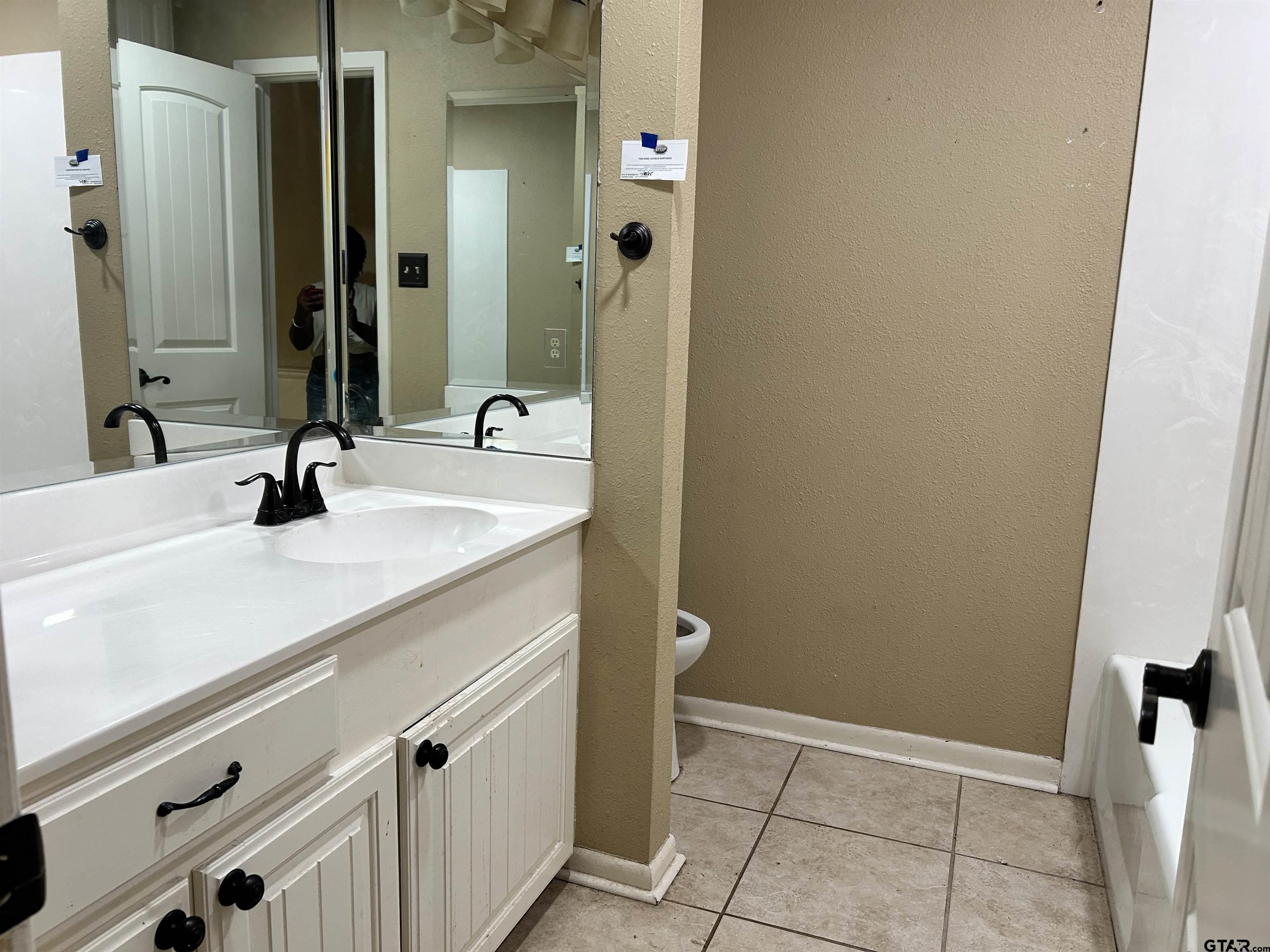 809 David Drive Tyler, TX 75703 - Photo 11 of 18 a bathroom with a sink a toilet and shower
