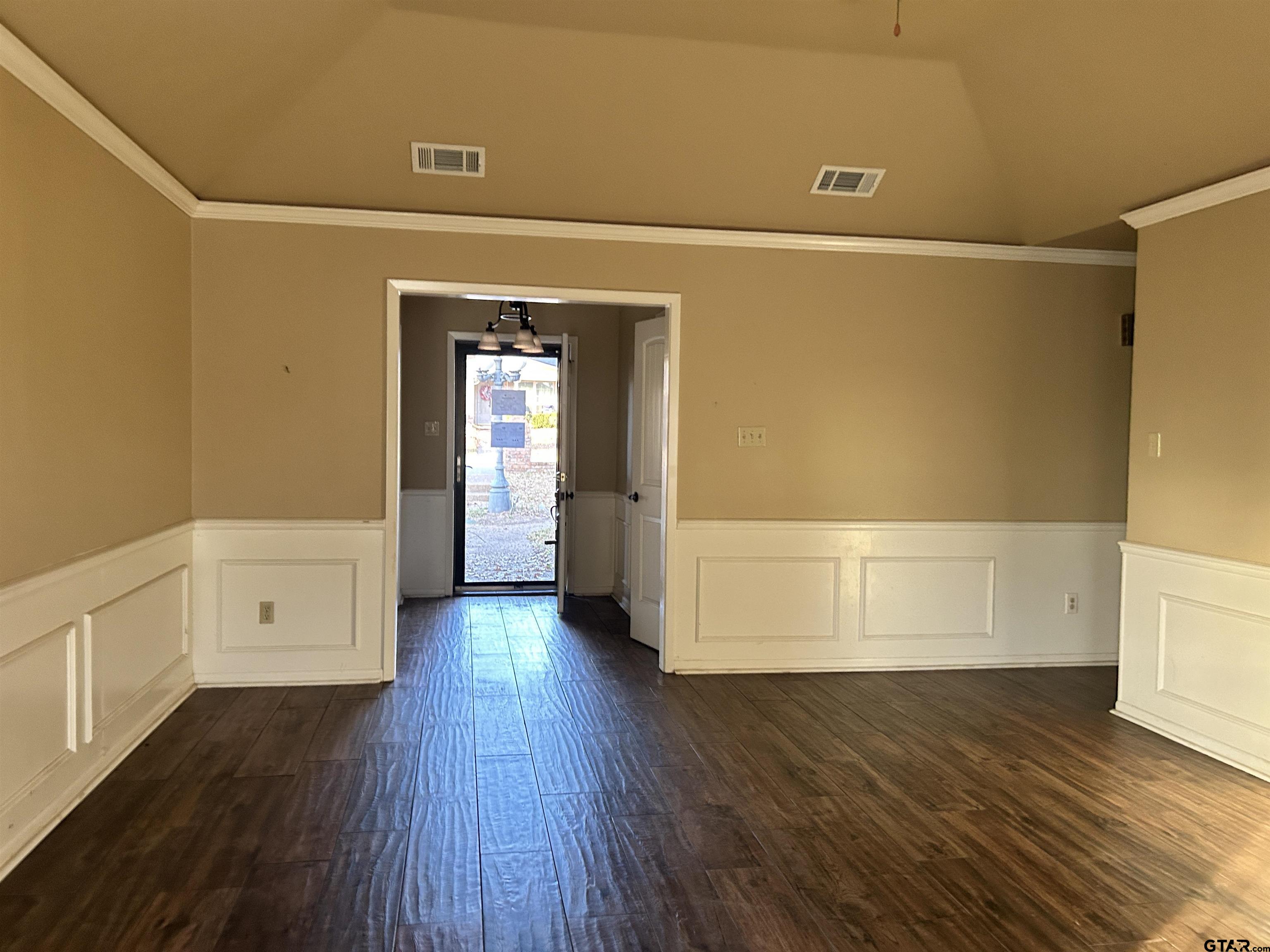 809 David Drive Tyler, TX 75703 - Photo 2 of 18 a view of an empty room with wooden floor and a window