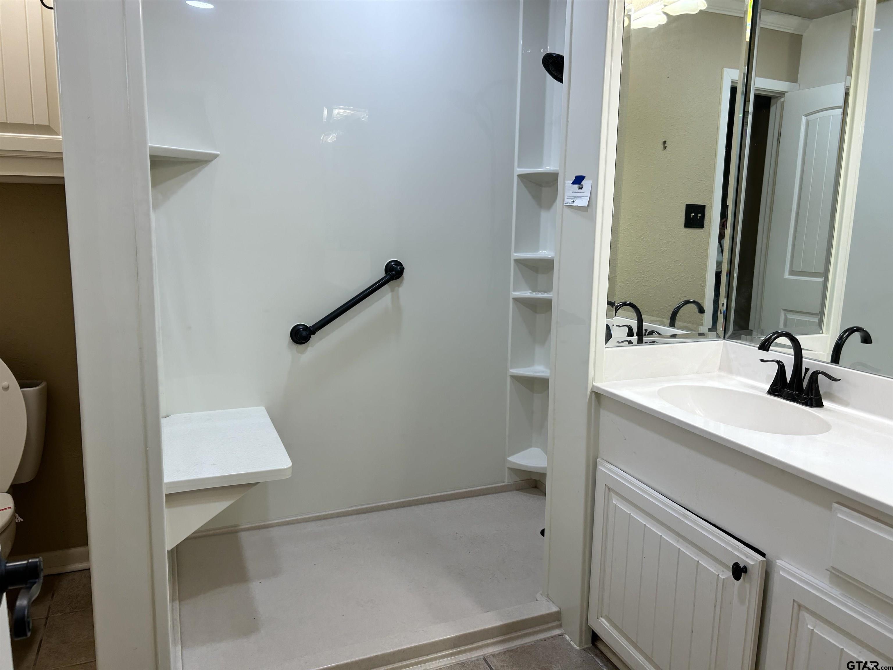 809 David Drive Tyler, TX 75703 - Photo 9 of 18 a bathroom with a sink a toilet and shower