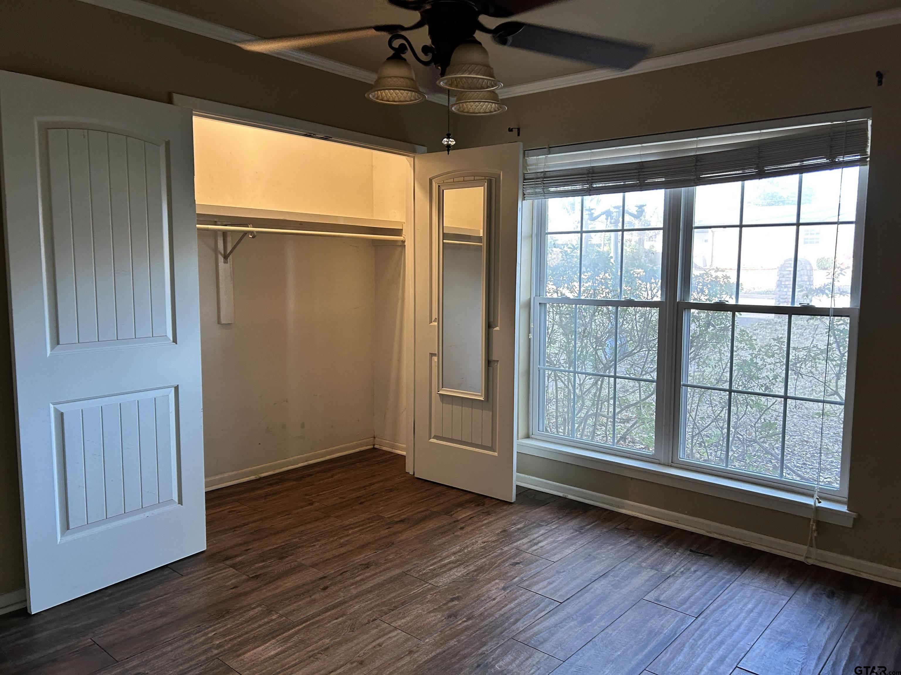809 David Drive Tyler, TX 75703 - Photo 10 of 18 an empty room with wooden floor and windows