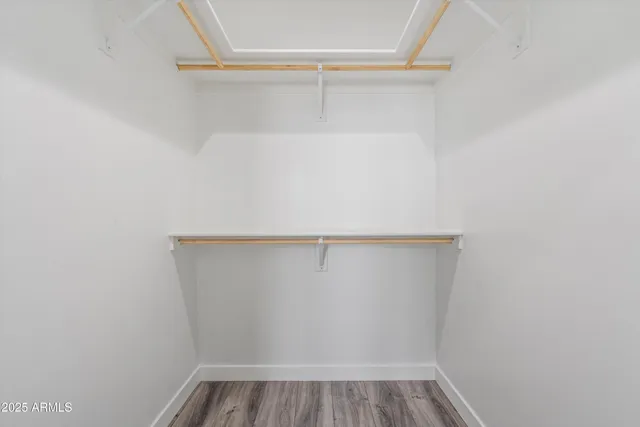 an empty room with a window and a ceiling fan