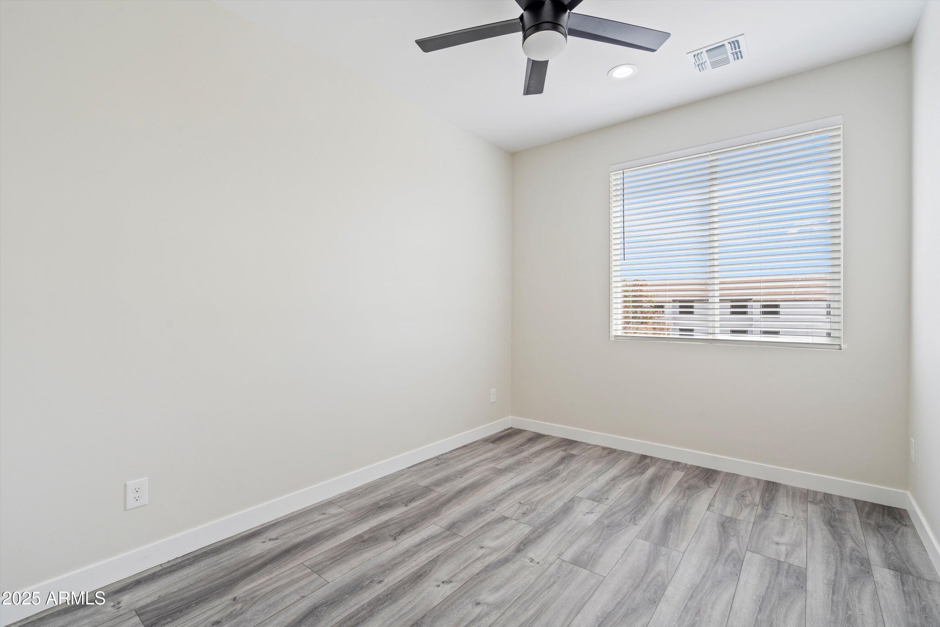 1642 East Monte Vista Road, Unit 1 Phoenix, AZ 85006 - Photo 26 of 34 an empty room with a window and a ceiling fan