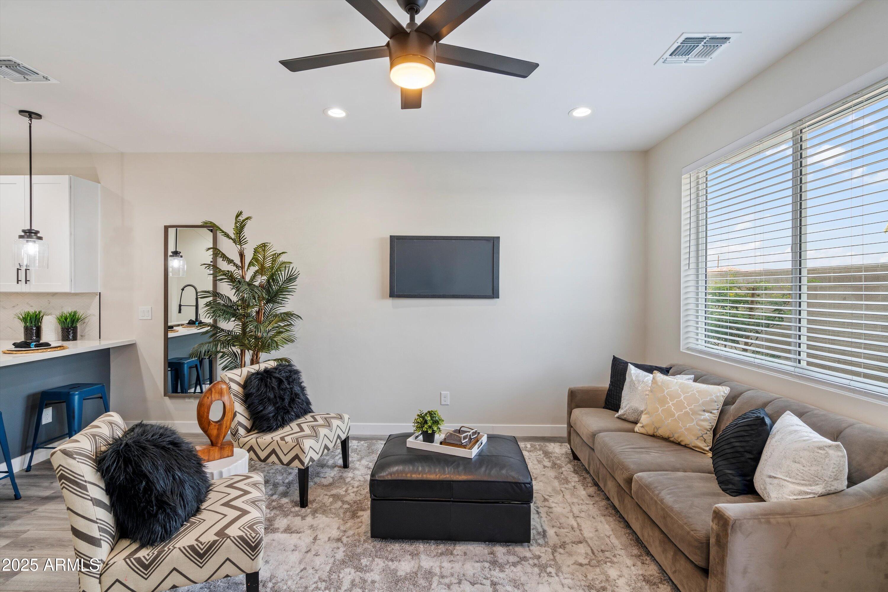 1642 East Monte Vista Road, Unit 1 Phoenix, AZ 85006 - Photo 3 of 34 a living room with furniture and a window