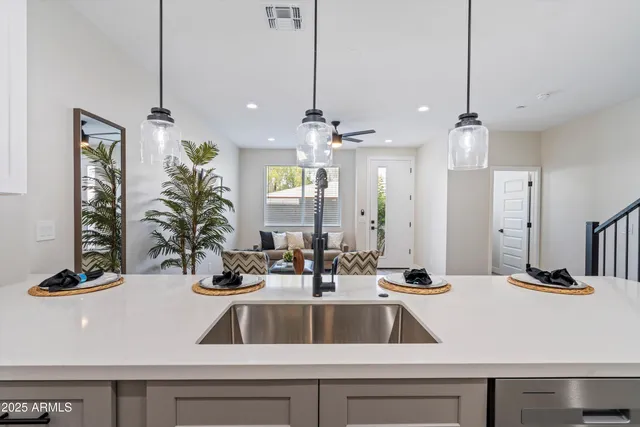 a view of a kitchen counter top a sink and refrigerator