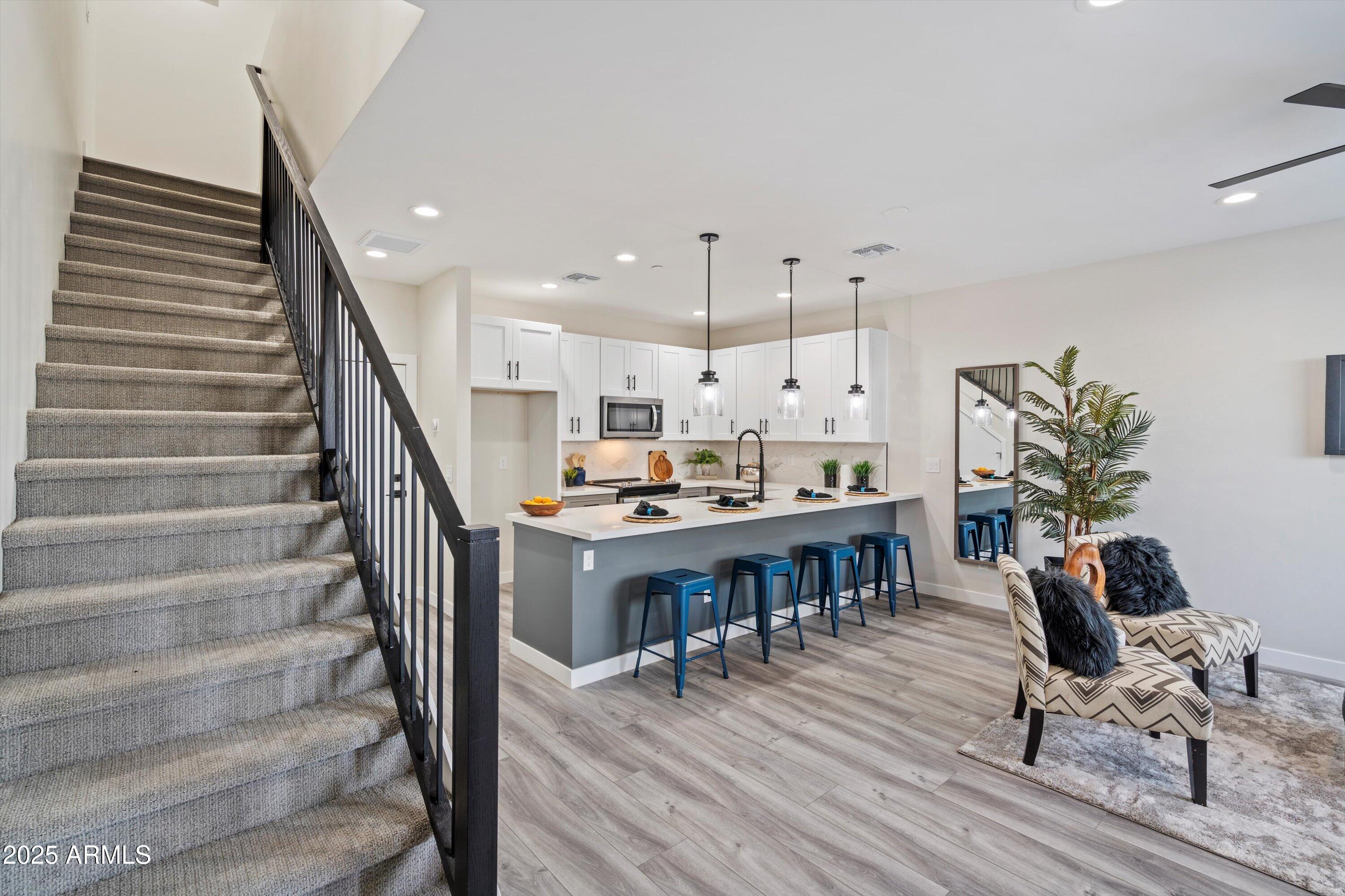 1642 East Monte Vista Road, Unit 1 Phoenix, AZ 85006 - Photo 10 of 34 a living room with furniture and a dining table with wooden floor