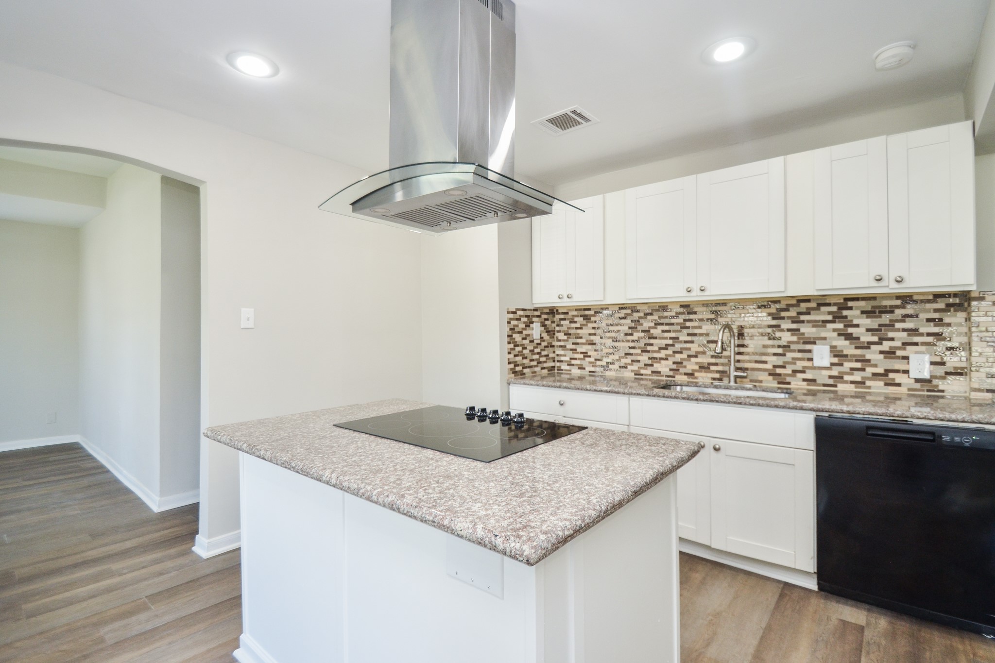 5238 Keystone Street Houston, TX 77021 - Photo 9 of 31 Sleek island with a cooktop and stainless steel range hood.
