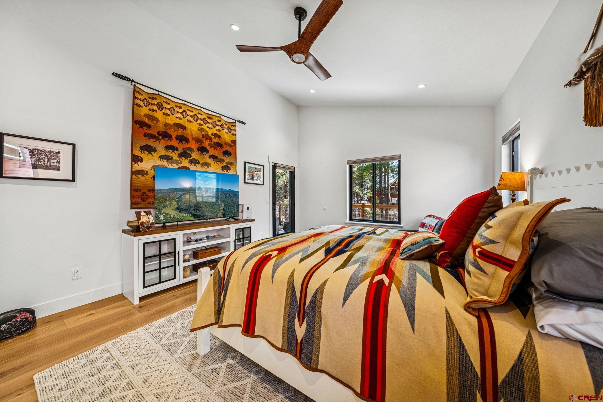 220 Edgemont Meadows Road Durango, CO 81301 - Photo 23 of 44 a bedroom with a bed and a flat screen tv