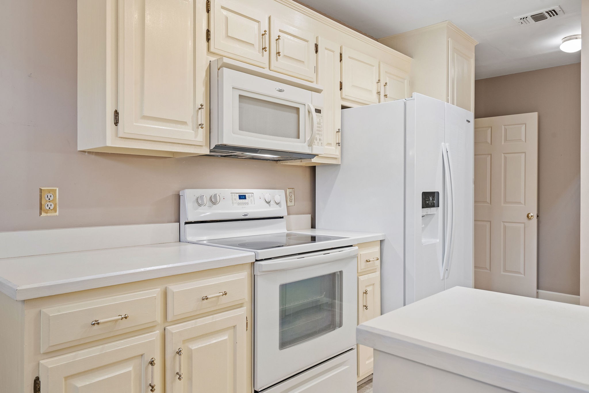 523 General George Patton Road Nashville, TN 37221 - Photo 9 of 30 a kitchen with white cabinets and white appliances