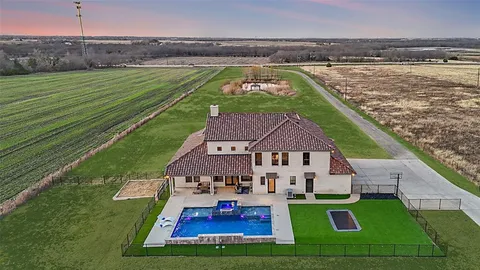 a aerial view of a house with swimming pool having outdoor seating
