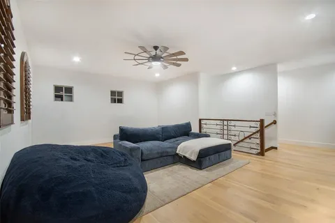 a bedroom with a bed a chair and a chandelier