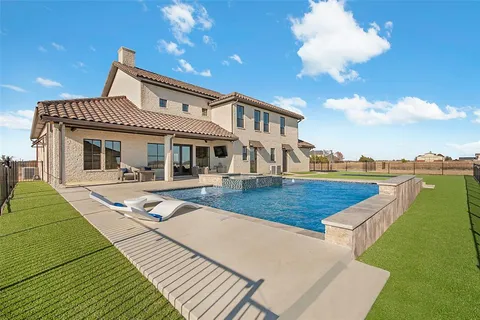 a view of an house with backyard space and ocean view