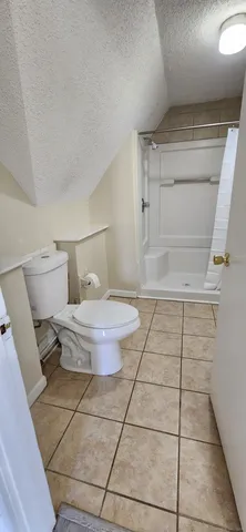 a bathroom with a toilet and a mirror