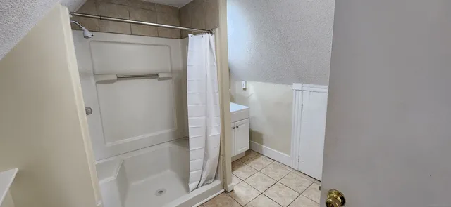 a bathroom with a glass shower door