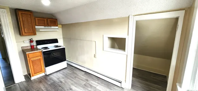a kitchen with a refrigerator and a stove