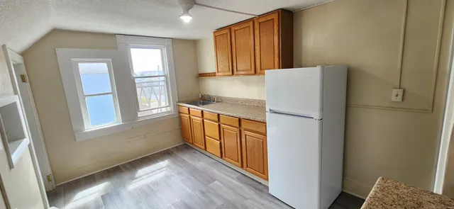 a kitchen with a refrigerator and a window