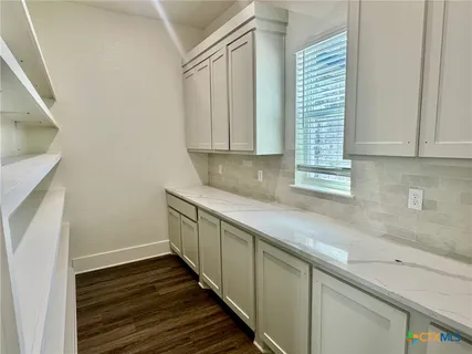 a kitchen with wooden cabinets and a sink