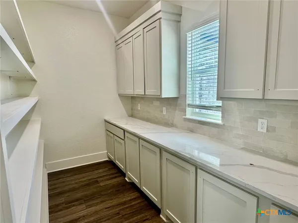 a kitchen with wooden cabinets and a sink