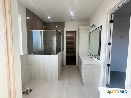 a bathroom with a glass shower door