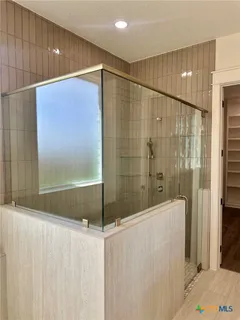 a bathroom with a shower and a tub