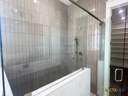 a bathroom with a shower and a sink