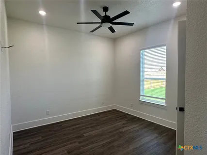 an empty room with wooden floor and closet