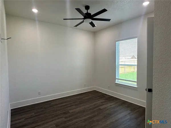 an empty room with wooden floor and closet