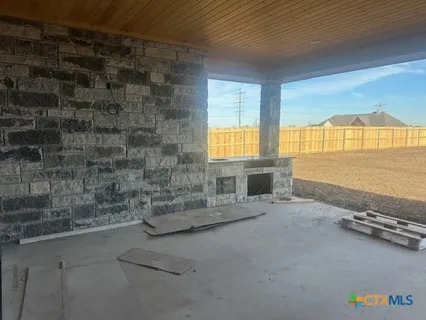 an empty room with a fireplace