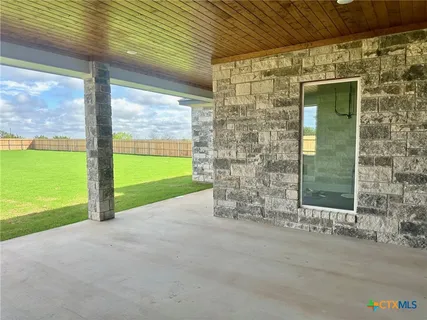 a view of a big yard with large trees