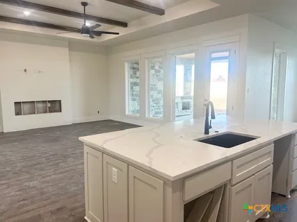 a kitchen with a sink and a white cabinets