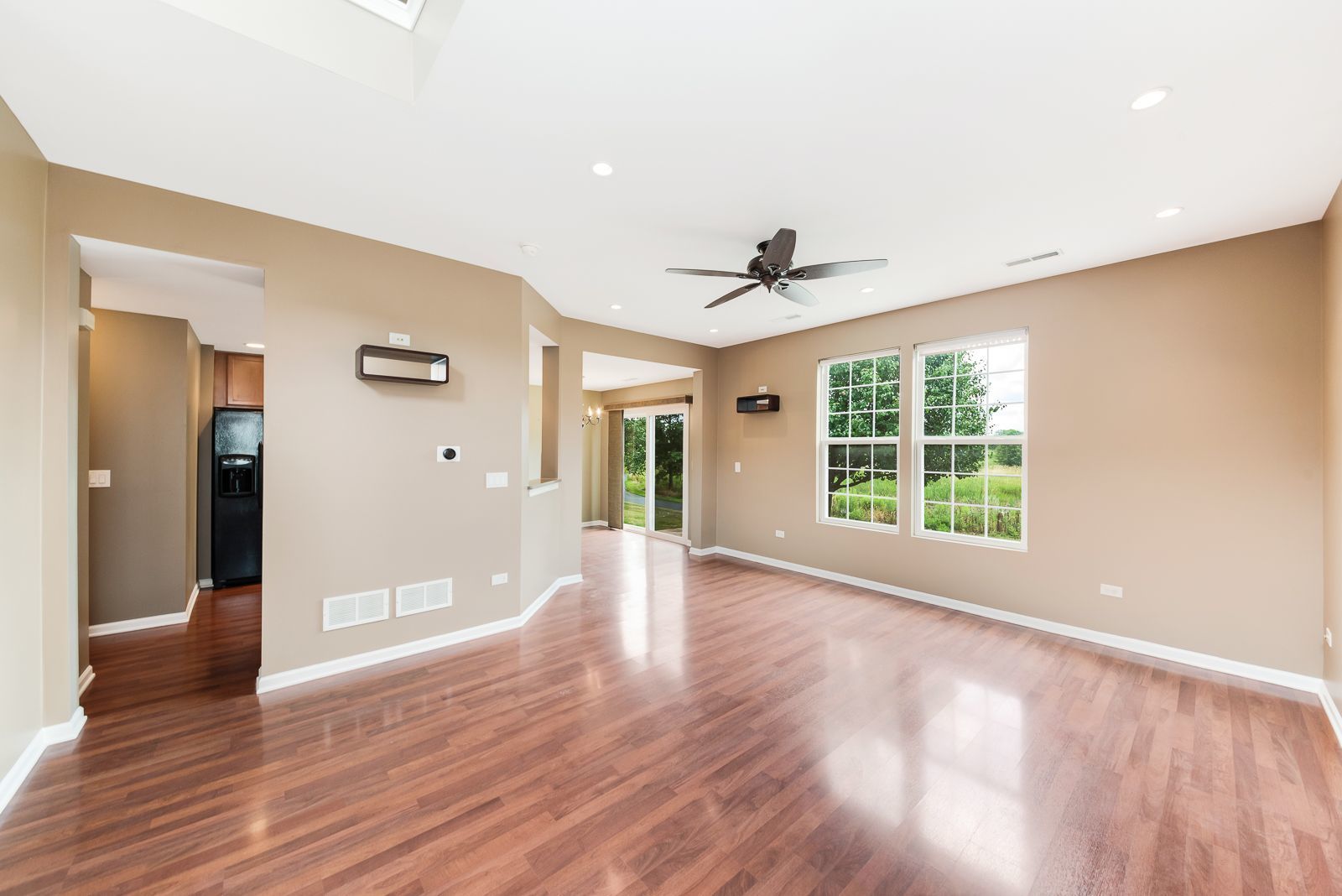 15305 Pinewood Road, Unit 15305 Lockport, IL 60441 - Photo 5 of 19 a view of an empty room with wooden floor and a window