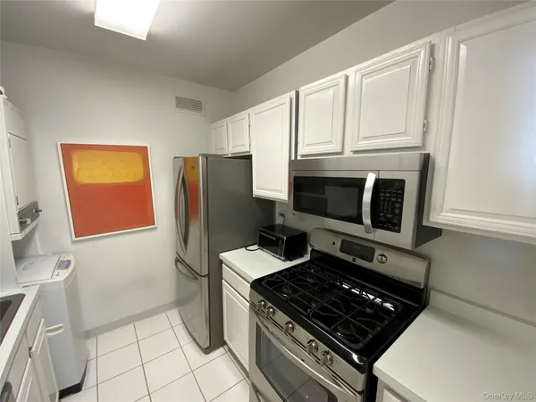 a kitchen with granite countertop a stove and a refrigerator