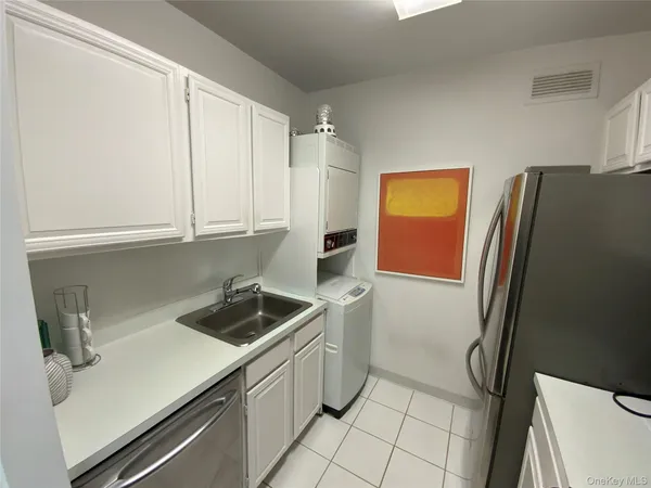 a kitchen with stainless steel appliances a refrigerator sink and cabinets