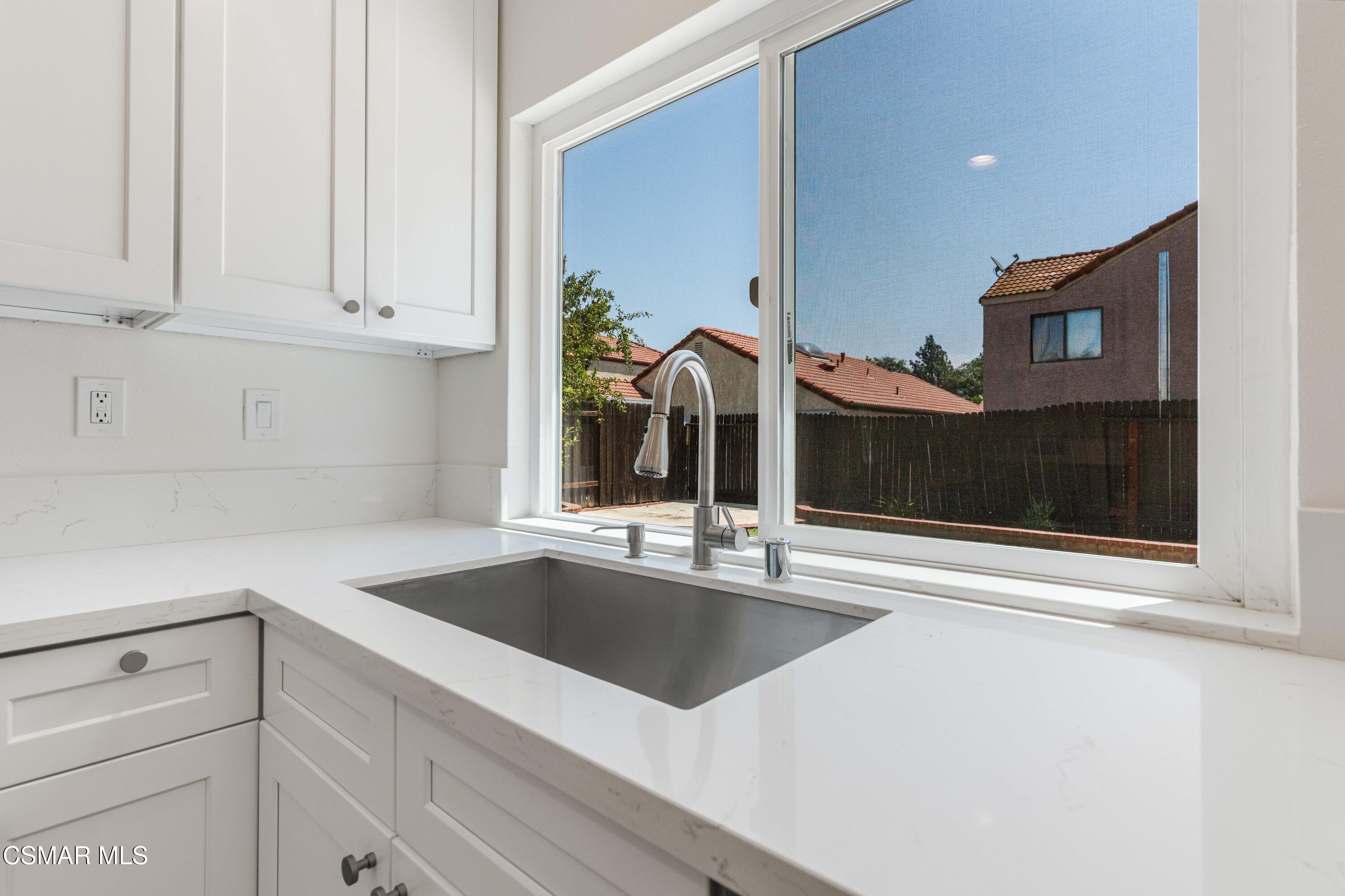 2332 Hampton Avenue Simi Valley, CA 93063 - Photo 11 of 34 a kitchen with stainless steel appliances granite countertop a sink and a white cabinets