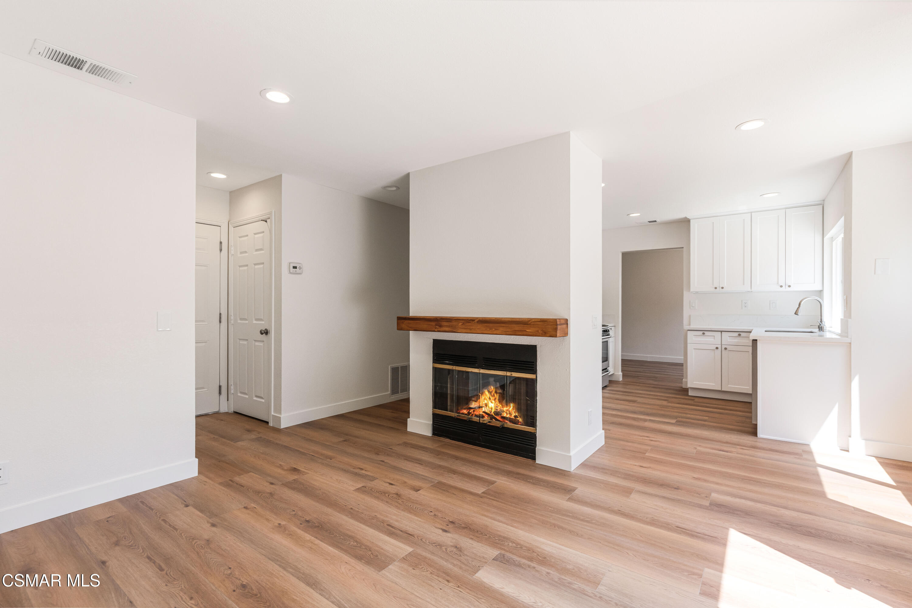 2332 Hampton Avenue Simi Valley, CA 93063 - Photo 13 of 34 a view of empty room with wooden floor and fireplace
