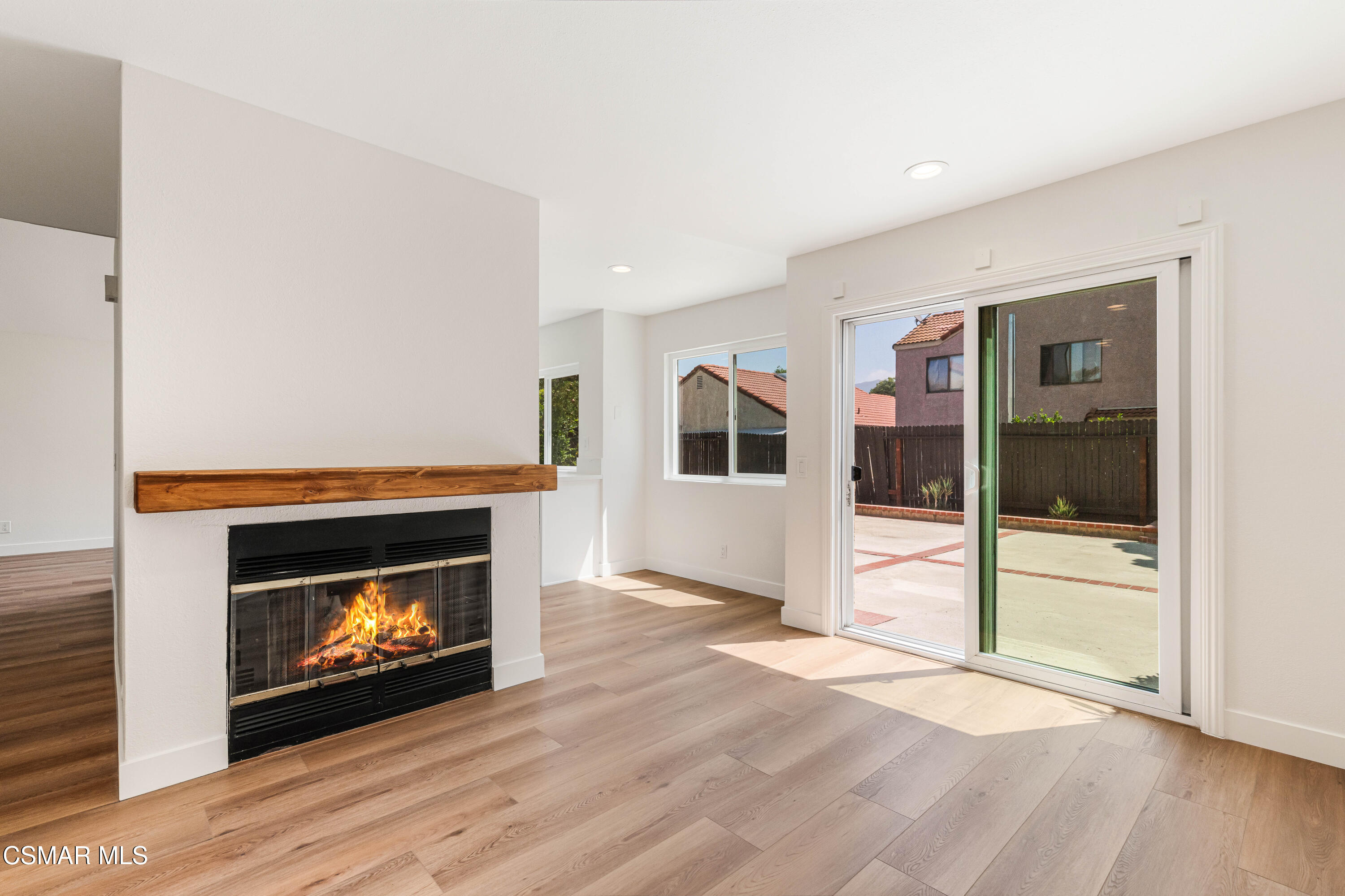 2332 Hampton Avenue Simi Valley, CA 93063 - Photo 14 of 34 a view of an empty room with wooden floor fireplace and a window