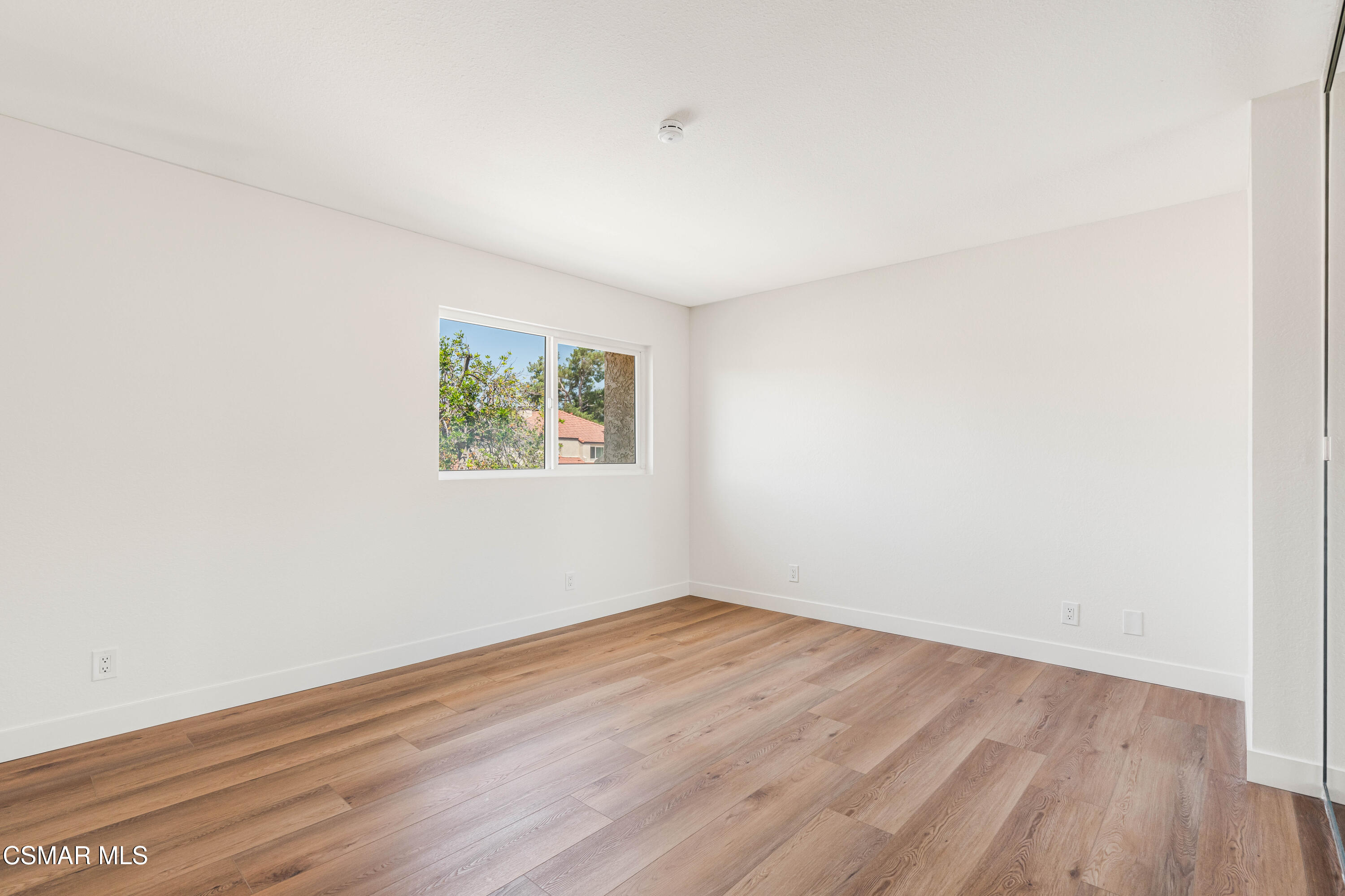 2332 Hampton Avenue Simi Valley, CA 93063 - Photo 19 of 34 an empty room with wooden floor and window