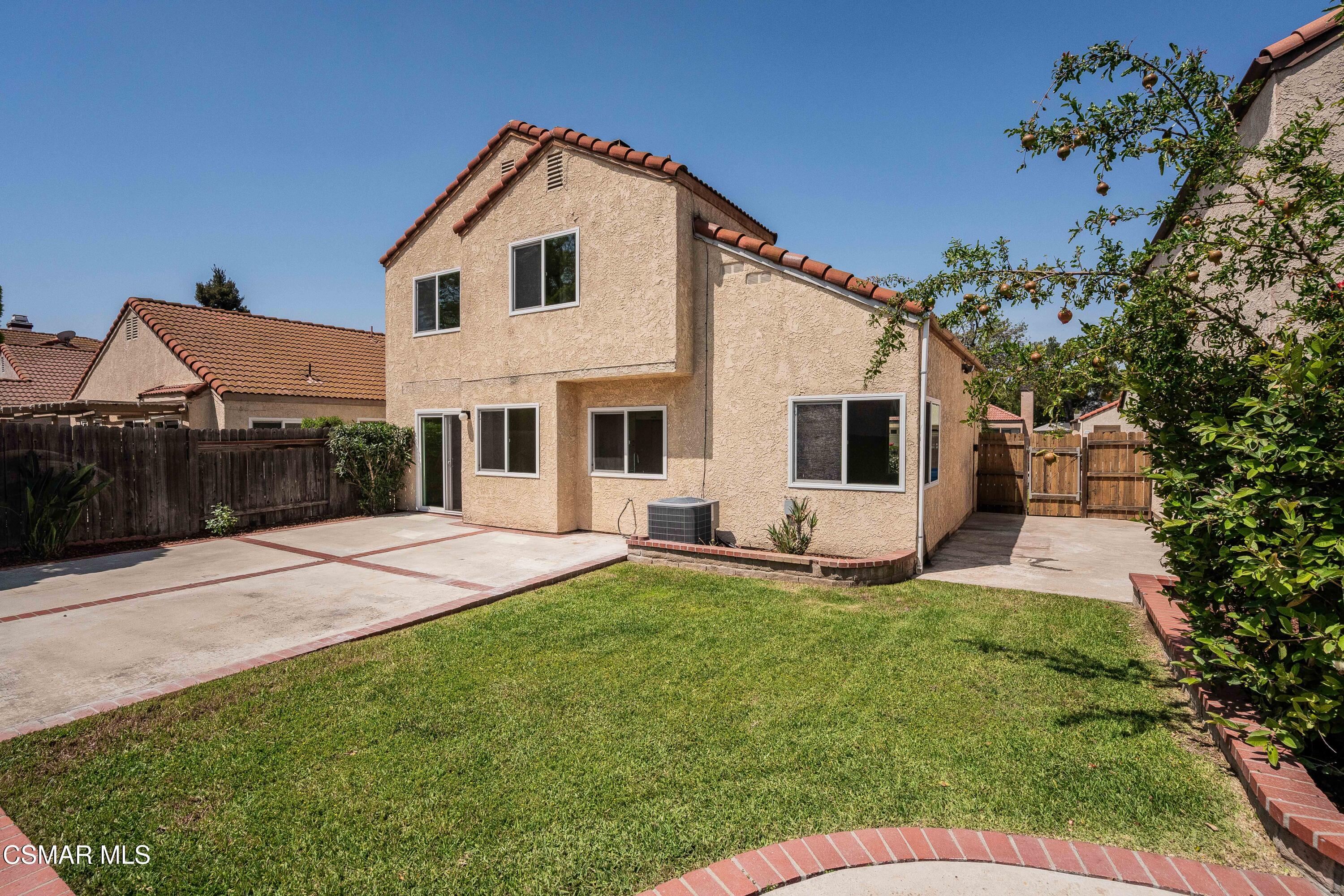 2332 Hampton Avenue Simi Valley, CA 93063 - Photo 2 of 34 a front view of a house with a yard and garage