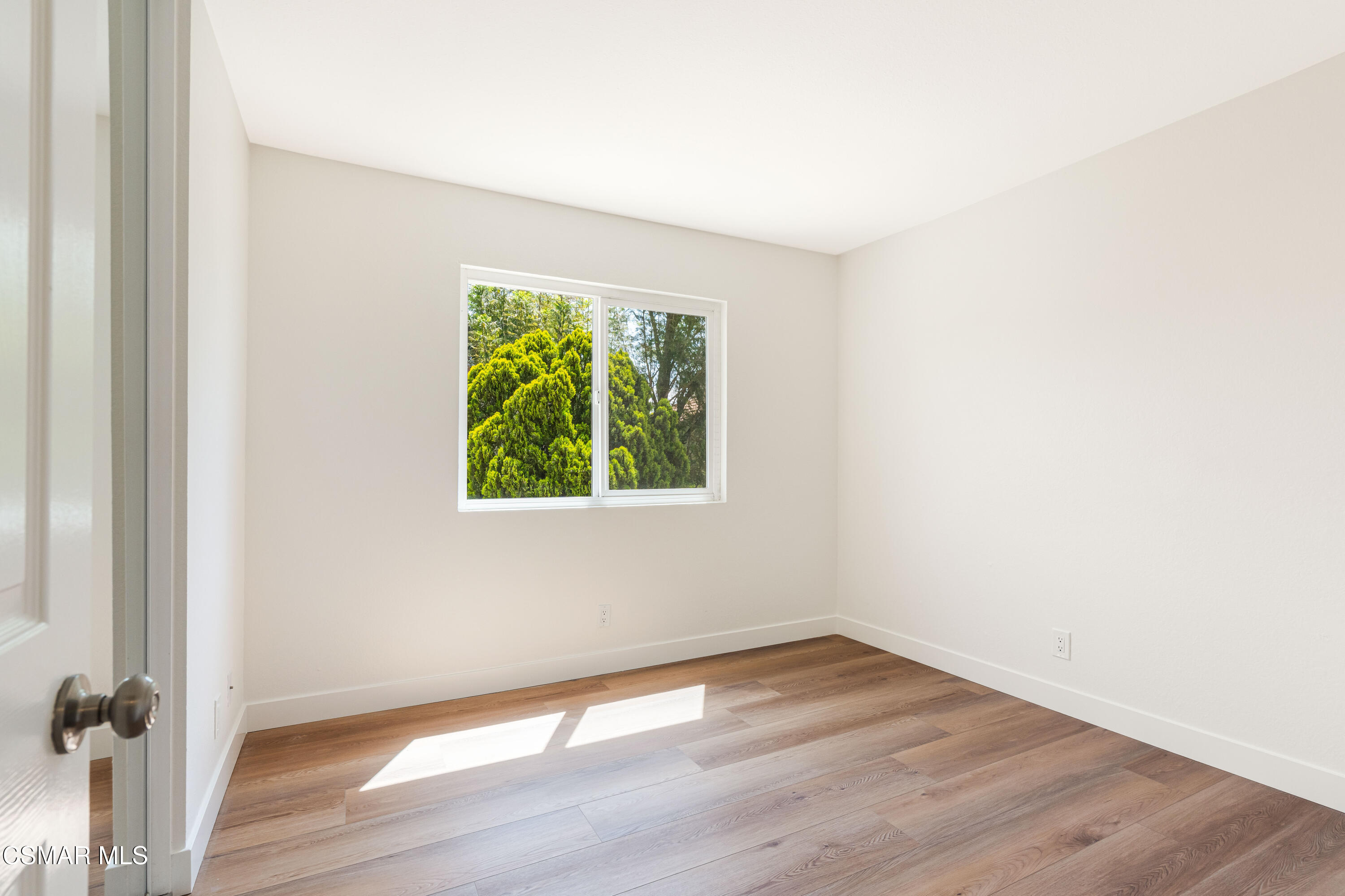 2332 Hampton Avenue Simi Valley, CA 93063 - Photo 23 of 34 an empty room with wooden floor and windows