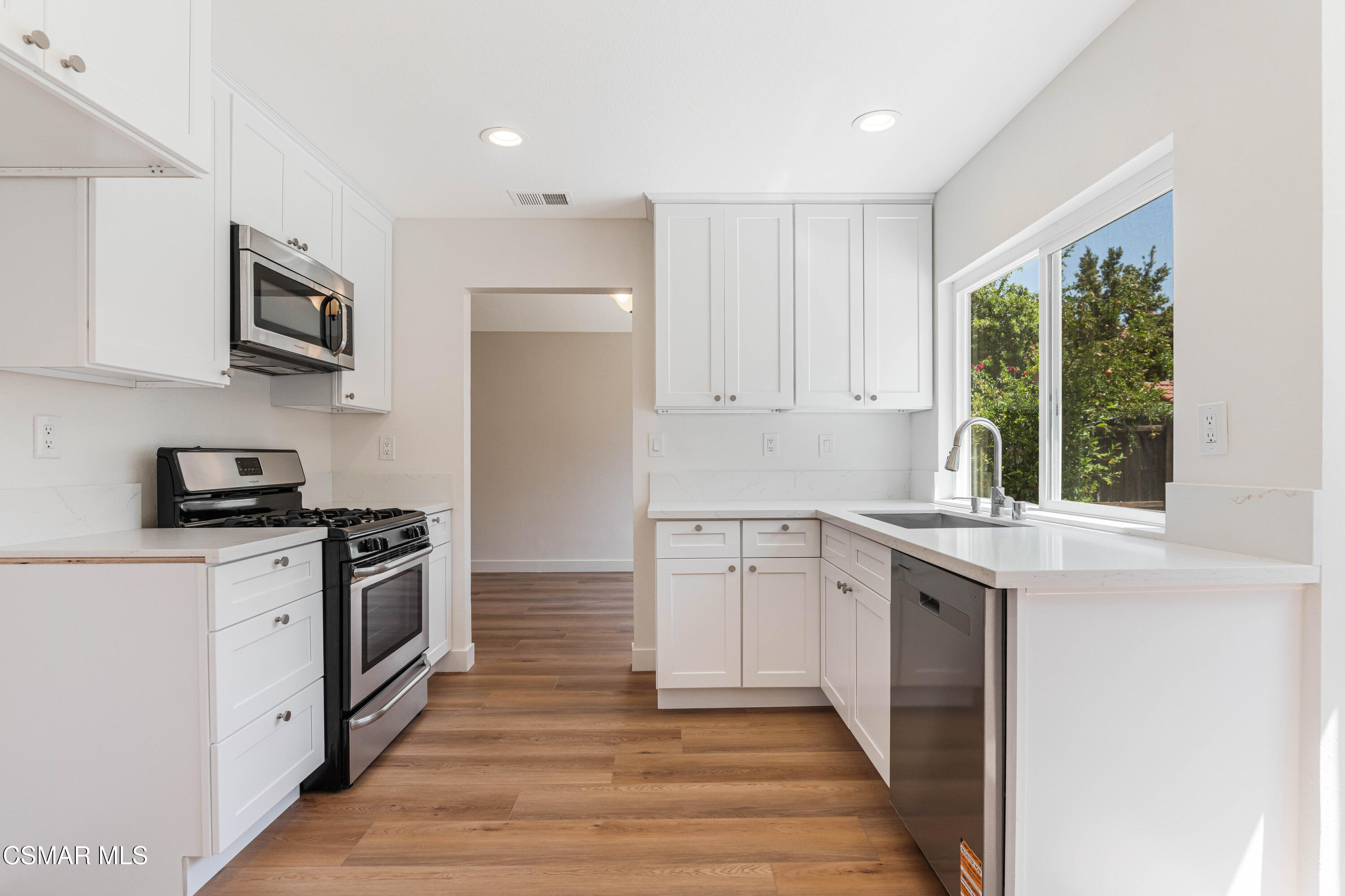 2332 Hampton Avenue Simi Valley, CA 93063 - Photo 10 of 34 a kitchen with stainless steel appliances granite countertop a stove a sink and a refrigerator